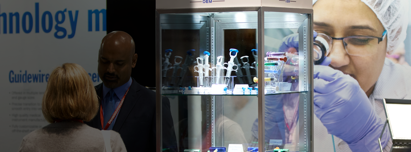 Man and woman talking in a medical device booth